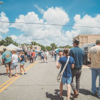 Gallery 1 - People enjoying artisans and vendors off main street.