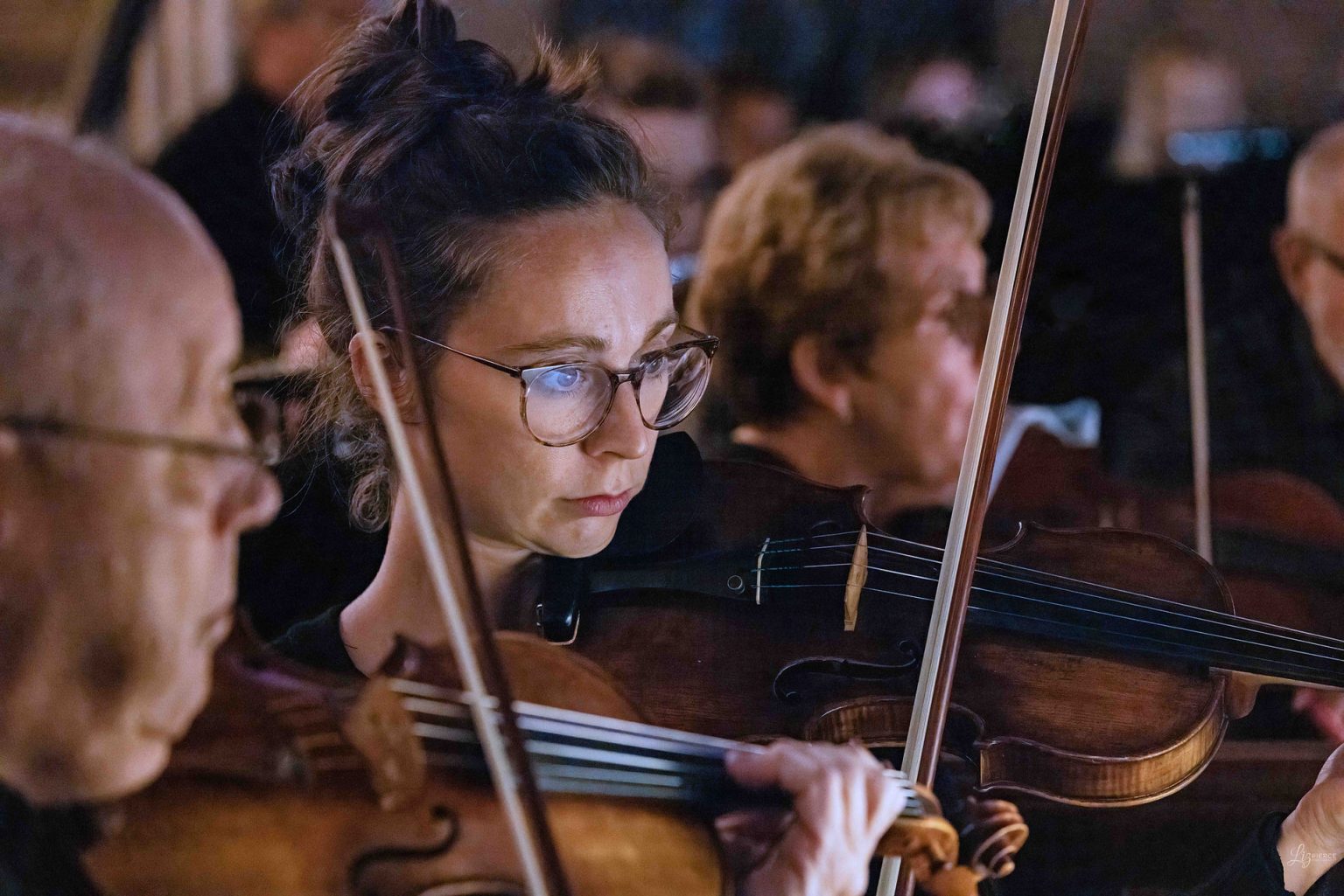 Gallery 3 - A close up of violinists playing