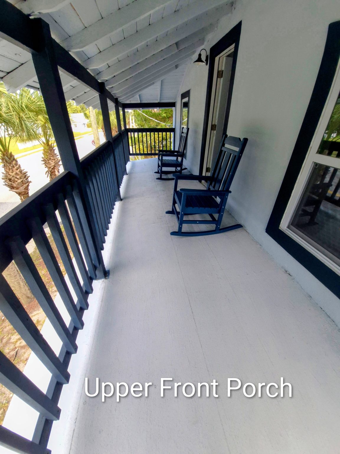 Gallery 3 - Historic Zora Neale Hurston Home's upper front porch with rocking chairs.