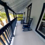 Gallery 3 - Historic Zora Neale Hurston Home's upper front porch with rocking chairs.
