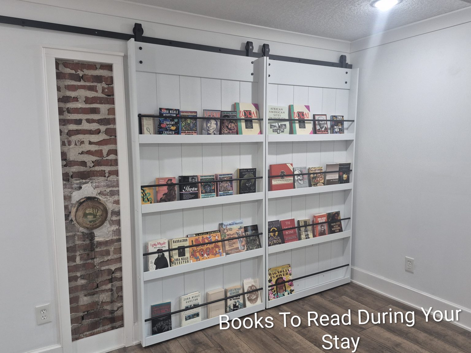 Gallery 5 - Historic Zora Neale Hurston Home Library wall with books available to read.